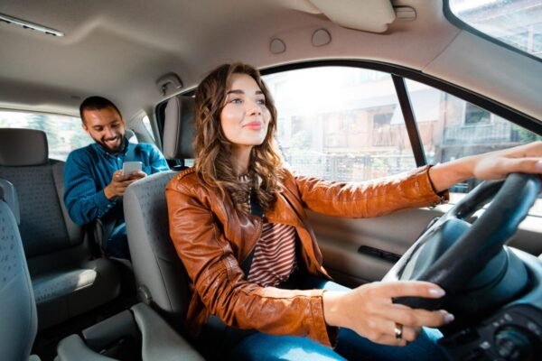 Uber and Lyft driver transporting passengers with rideshare insurance coverage